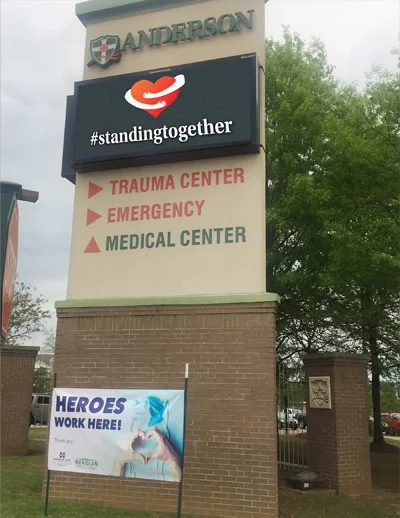 Hospital sign with #standing together and Heroes Work Here banner.