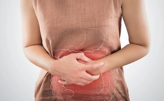 Person holding stomach, indicating digestive discomfort.