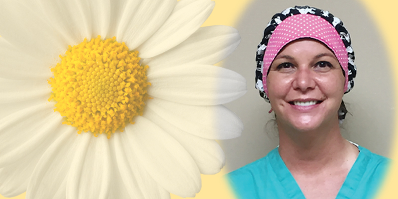 Woman with daisy, smiling, healthcare worker vibe.