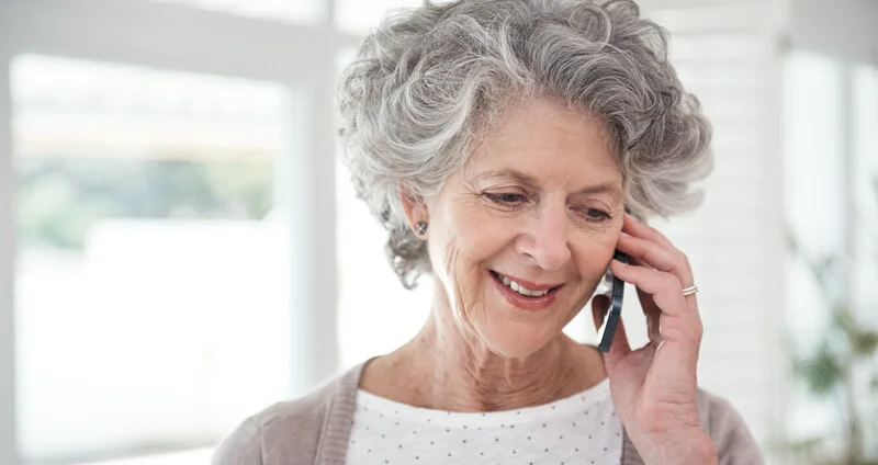 Senior woman smiling on phone call.