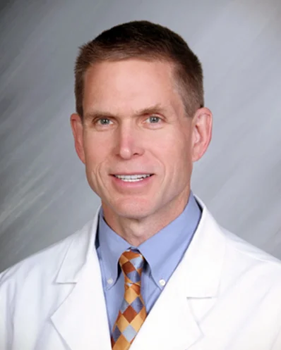 Professional man in white lab coat and tie.