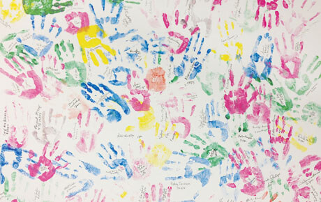 Colorful handprint mural background.