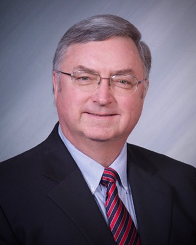 Professional man in glasses with striped tie and suit.