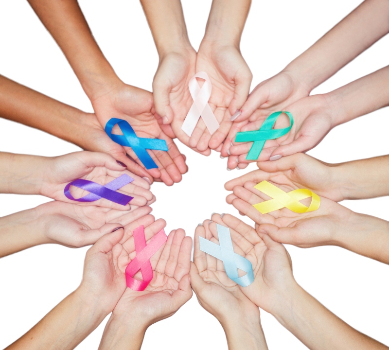 Hands holding multicolored awareness ribbons.