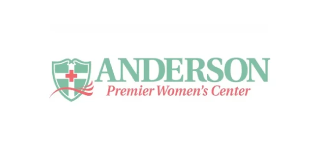 Logo of Anderson Premier Women's Center with shield and cross.