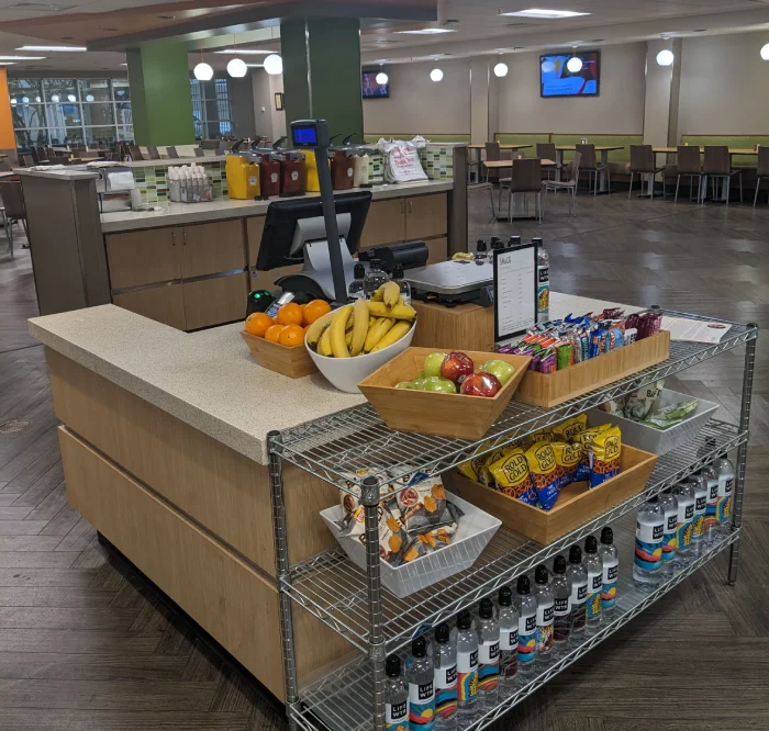 Modern cafeteria interior with self-service food counter.