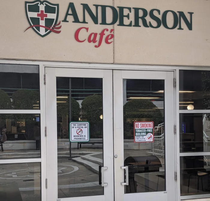 Anderson Café entrance with no smoking and gun signs.