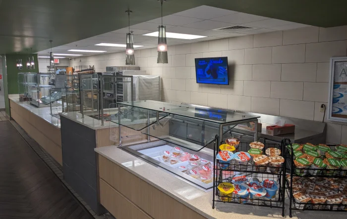 Interior of modern deli counter with food displays.